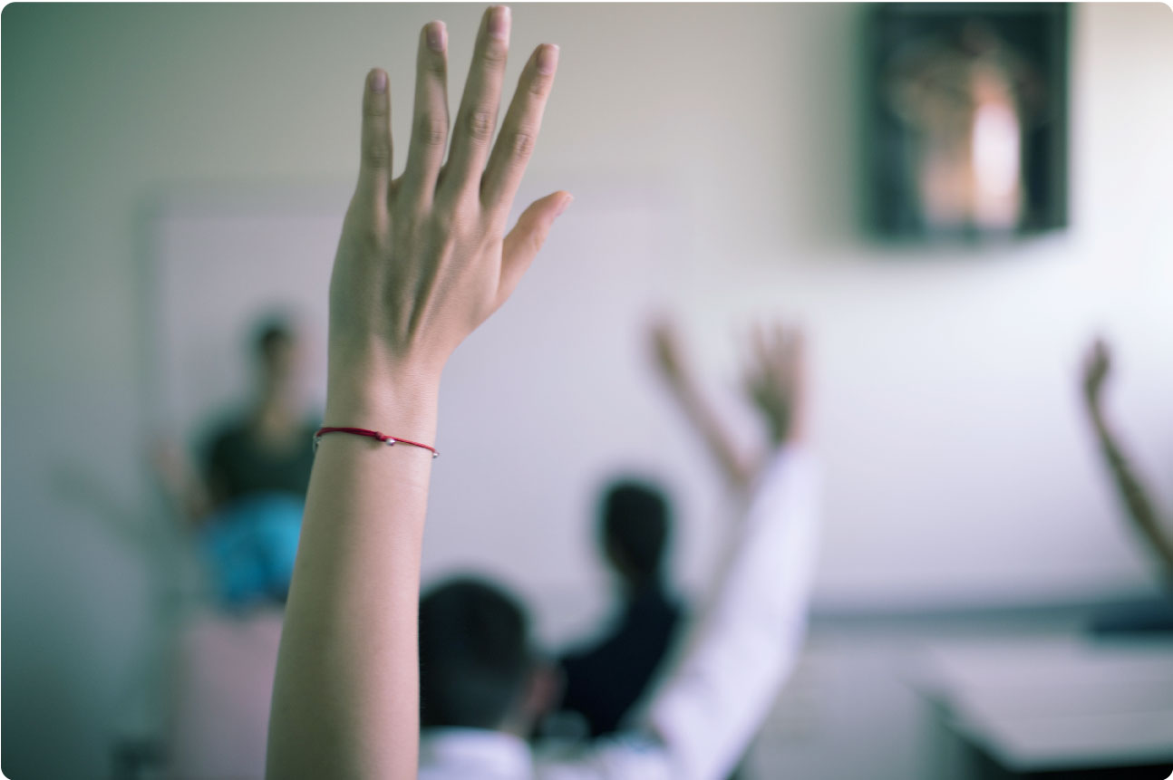 Person raising their hand to ask a question